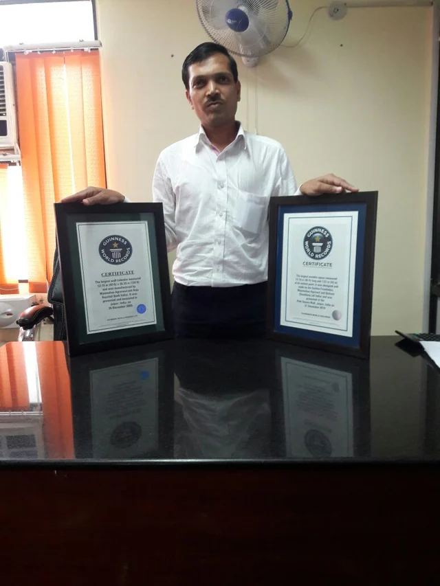 An individual record holder with two framed certificates
