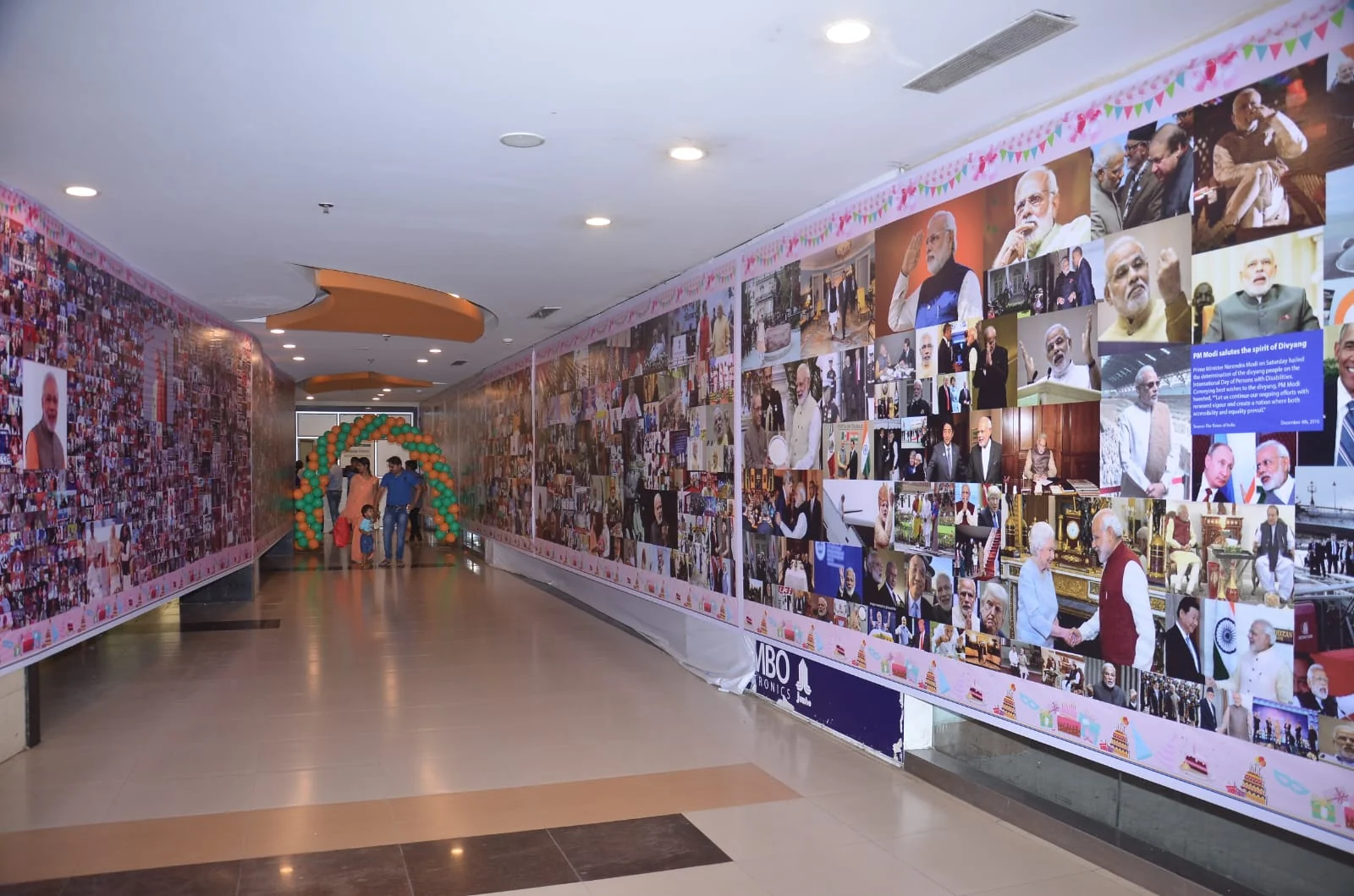 Visitors walking the length of the photograph exhibition